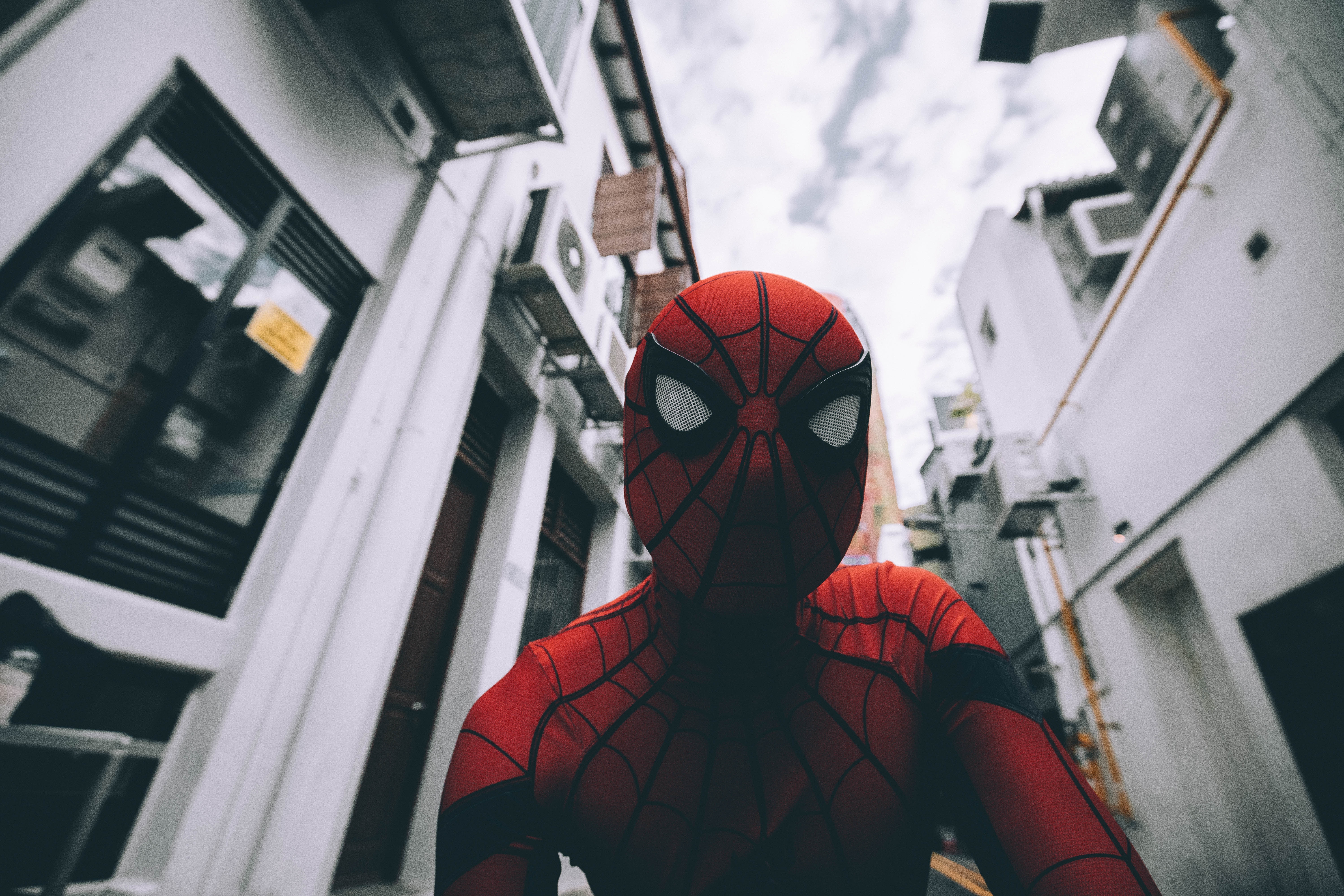 Spiderman seen between two buildings