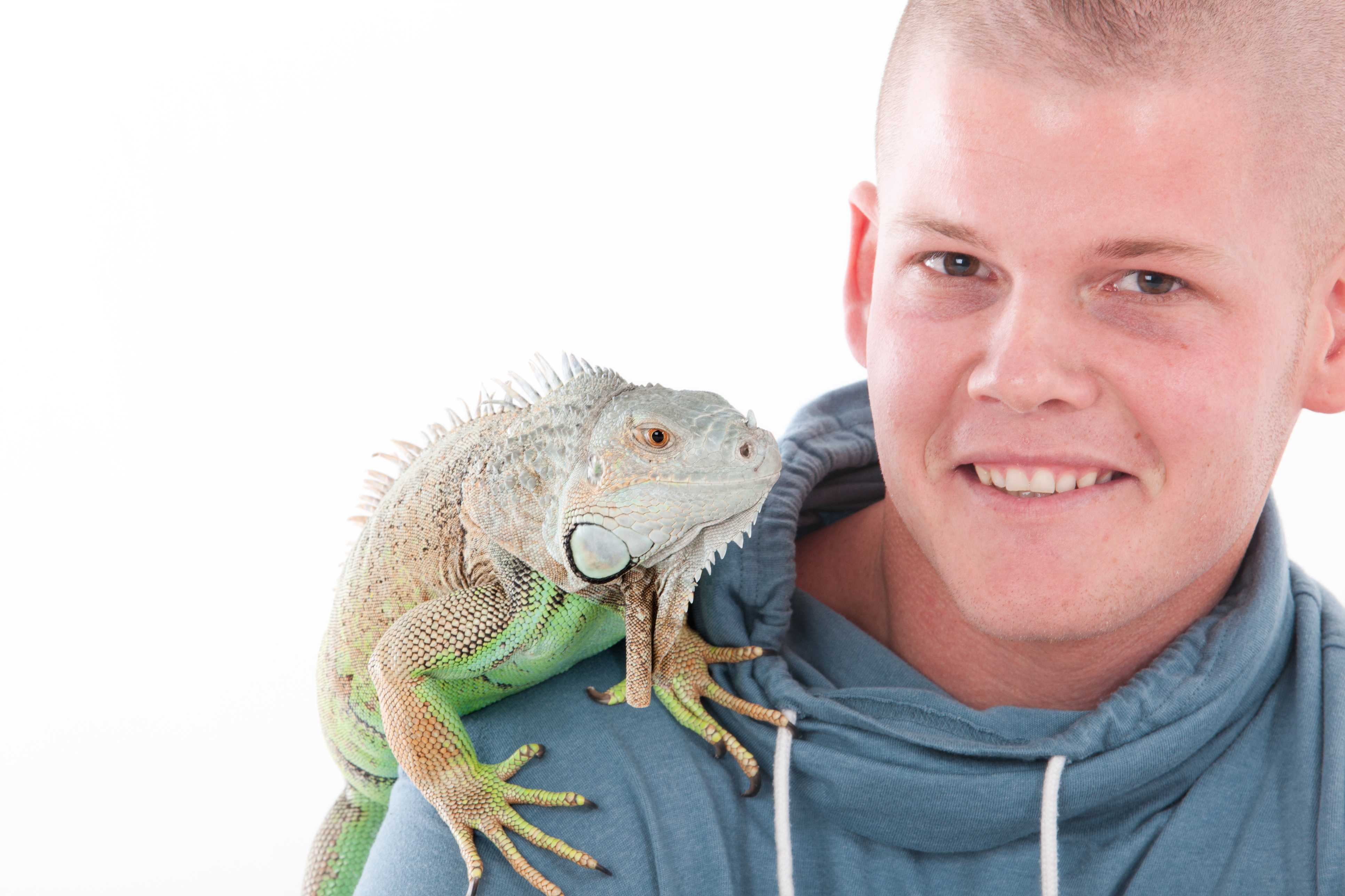 Boy with a large lizard on his shoulder