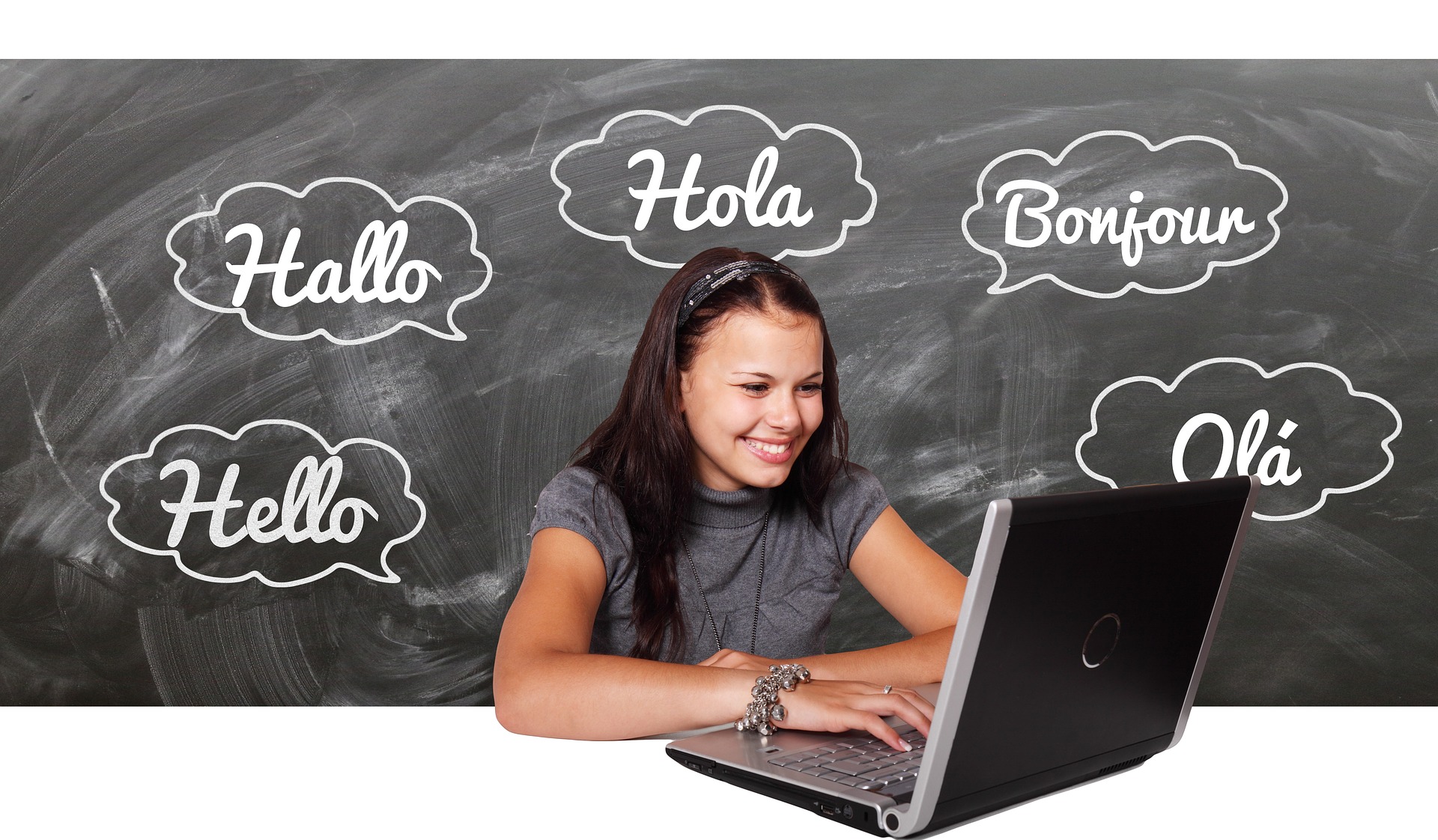 The word Hello written in different languages behind girl with laptop