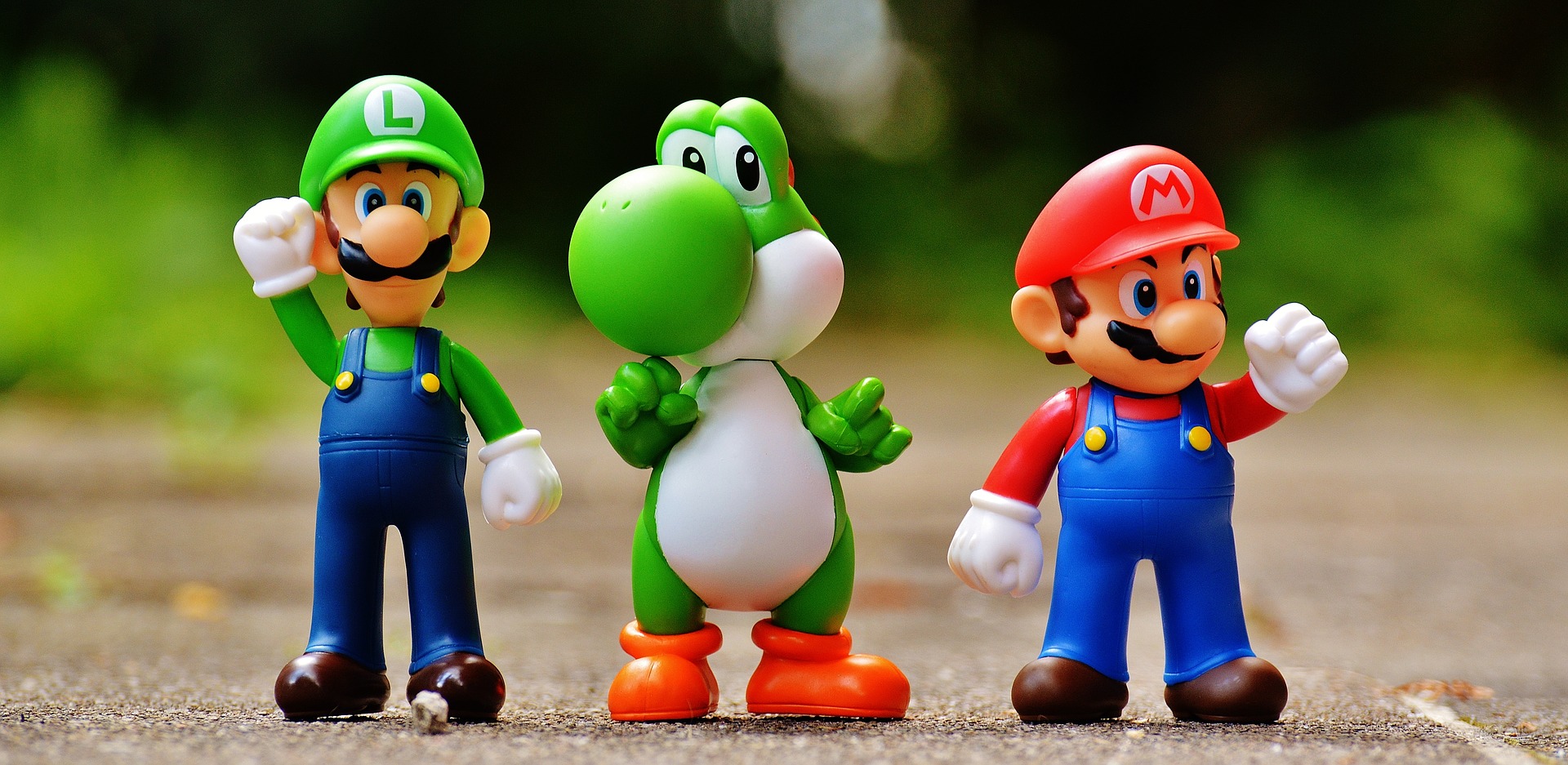 Mario, Luigi, and Yoshi raise fists of triumph.