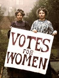 Historical photo of two women holding a sign "Votes for Women"