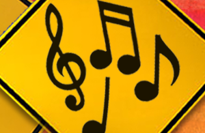Treble clef and music notes on a yellow sign.