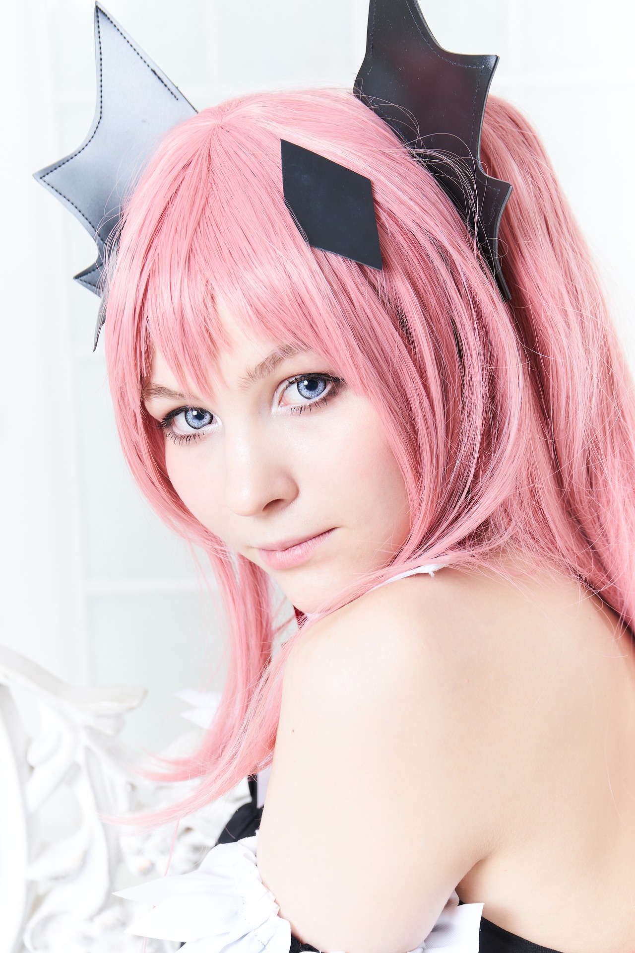 Teenage girl in cosplay with pink wig