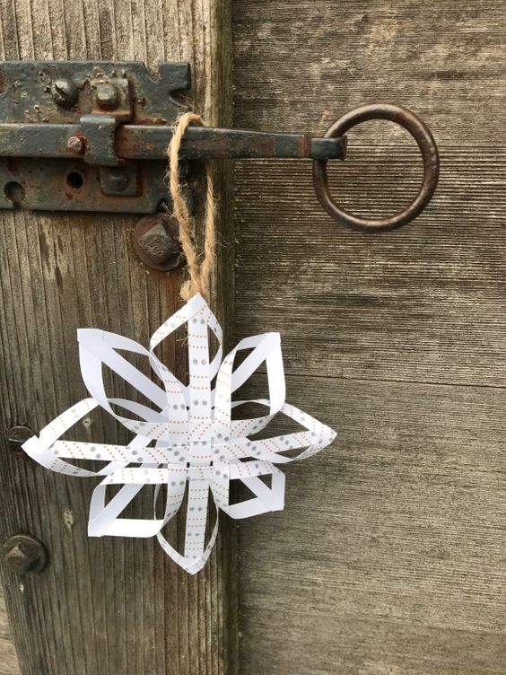 swedish star made of paper hangs on a wooden door