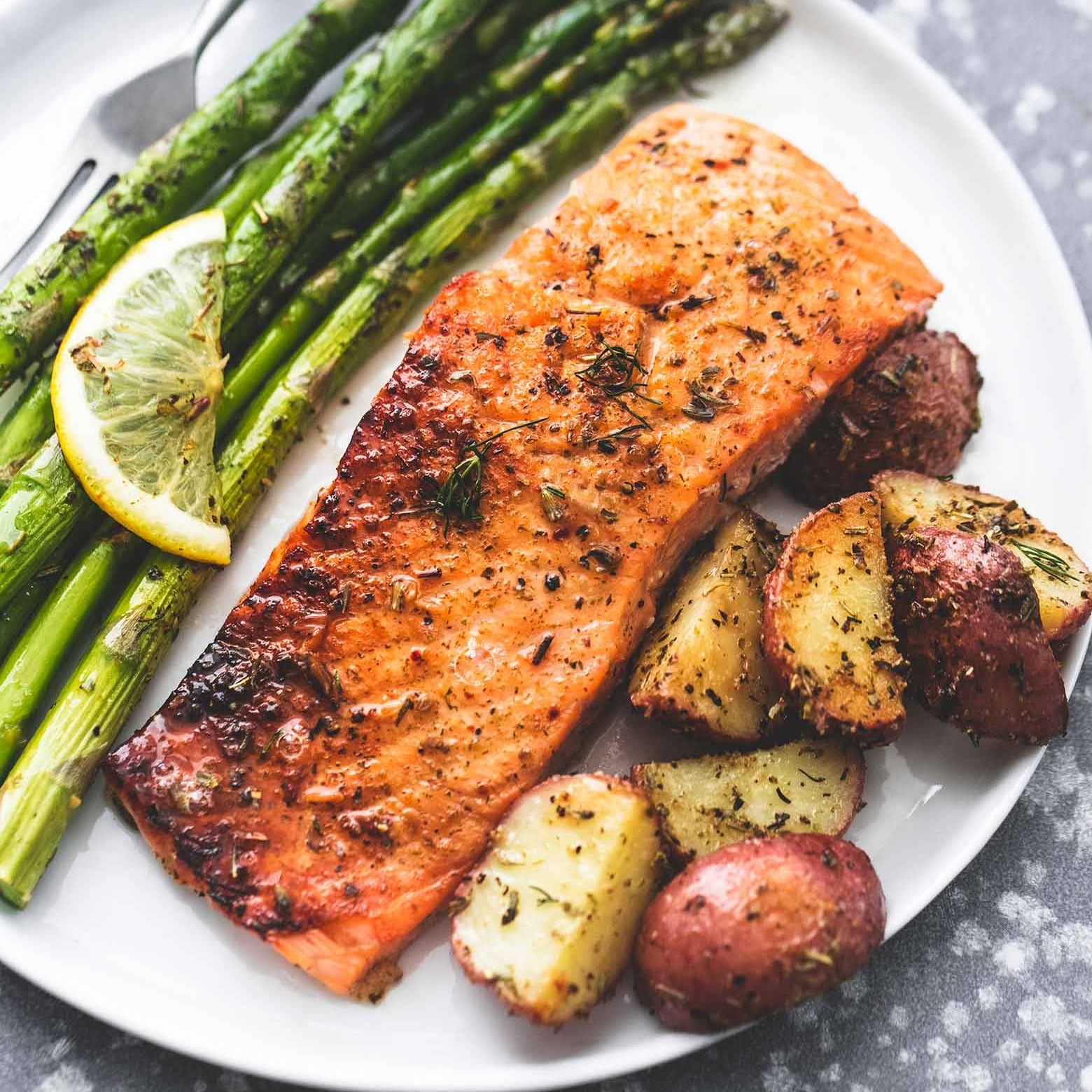 salmon,  potatoes and asparagus on a plate