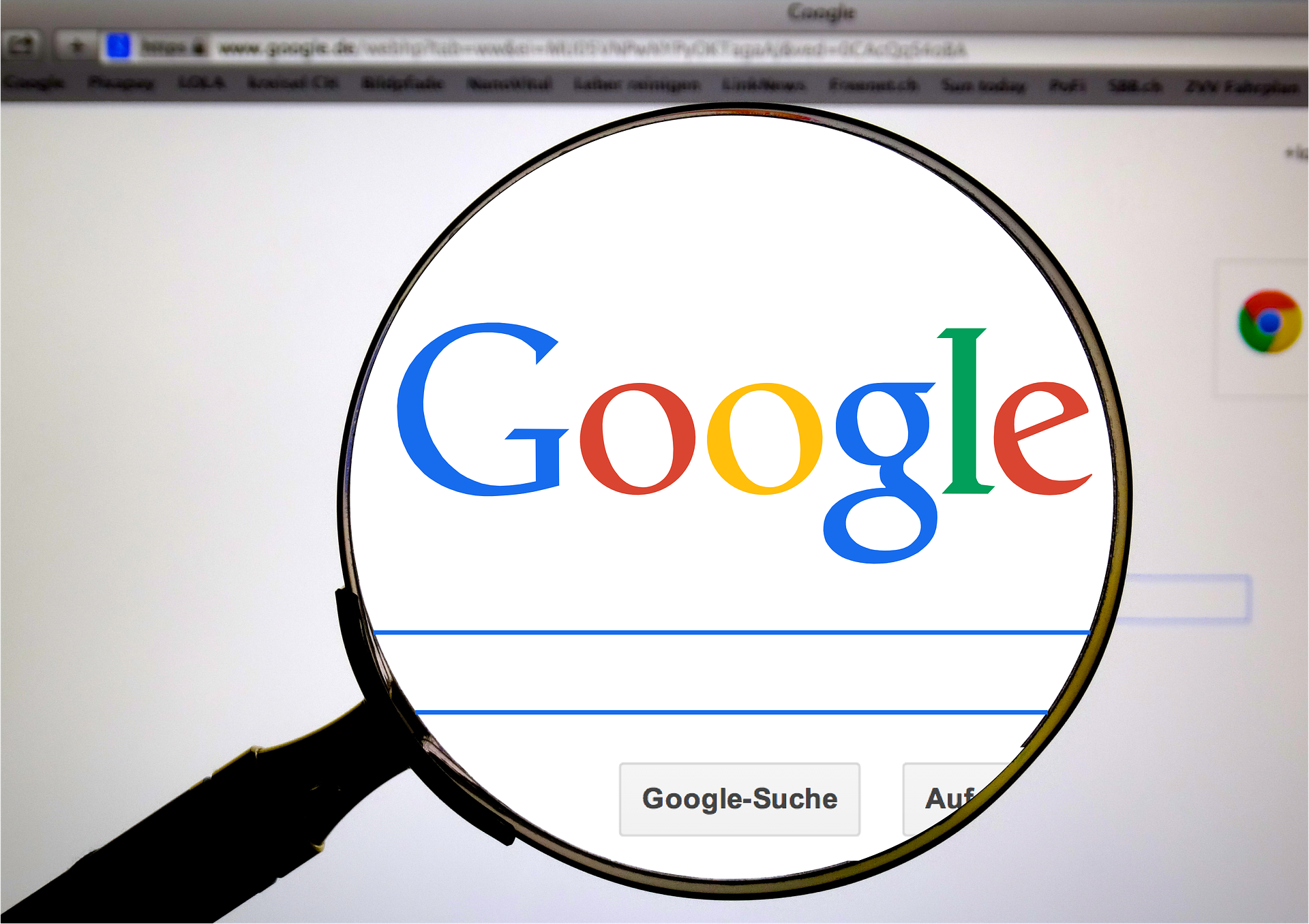 A magnifying glass centered over the Google logo on a Google search page.