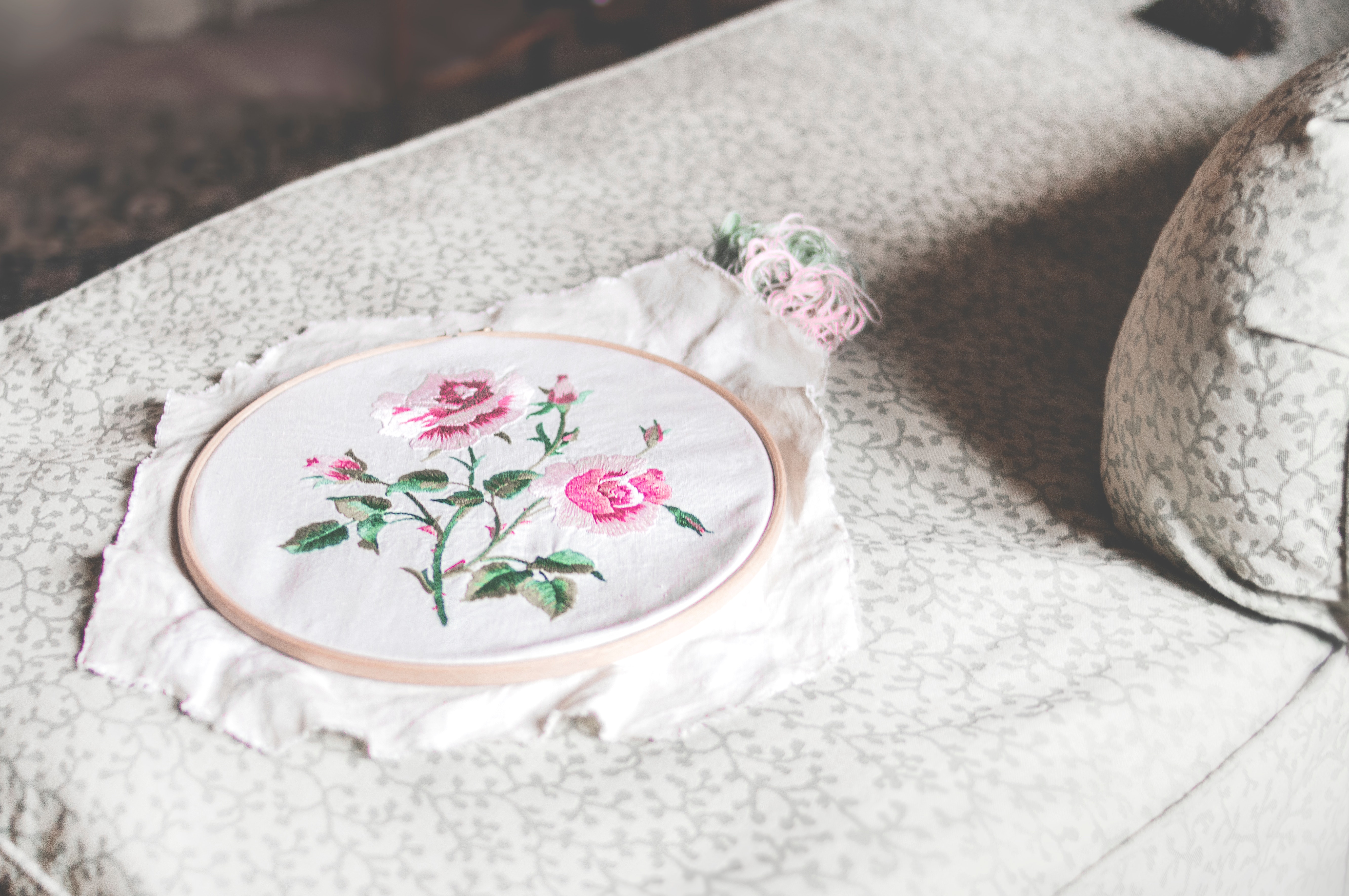 embroidered rose in a hoop on a calming table