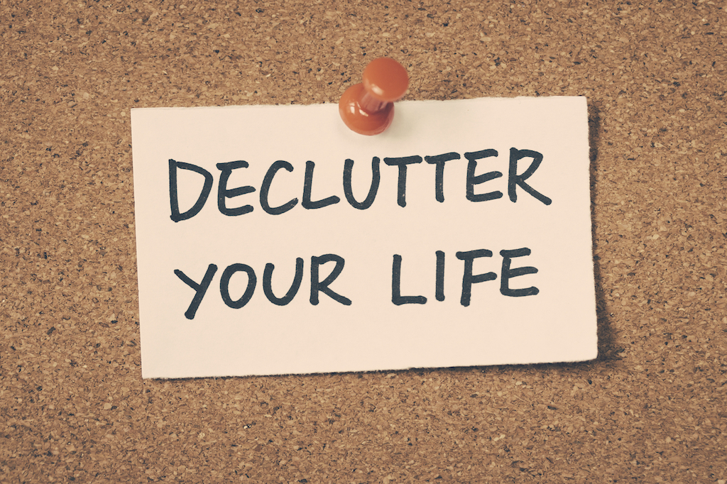sign "Declutter Your Life" on cork board
