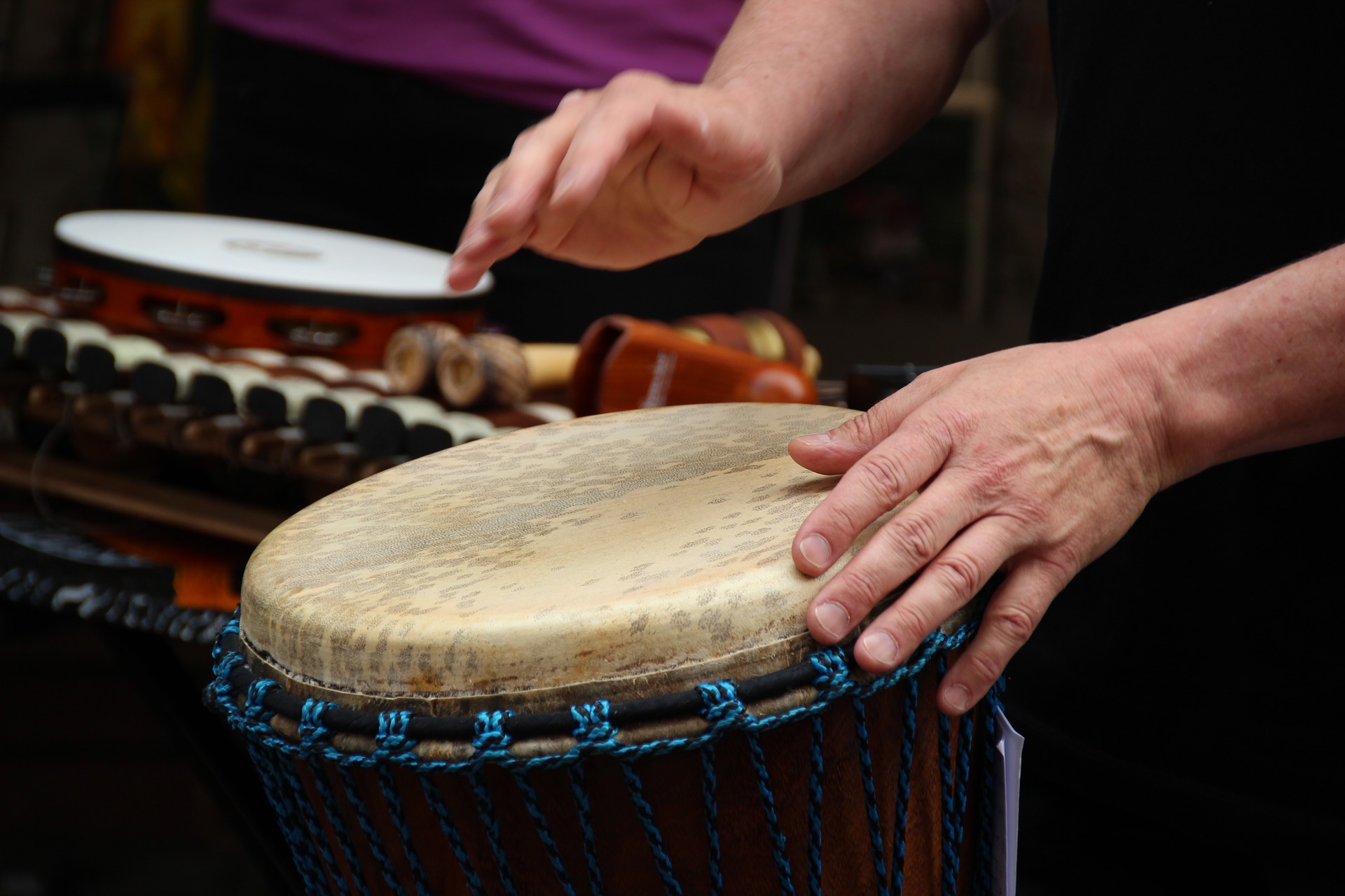 Hands hitting a drum.
