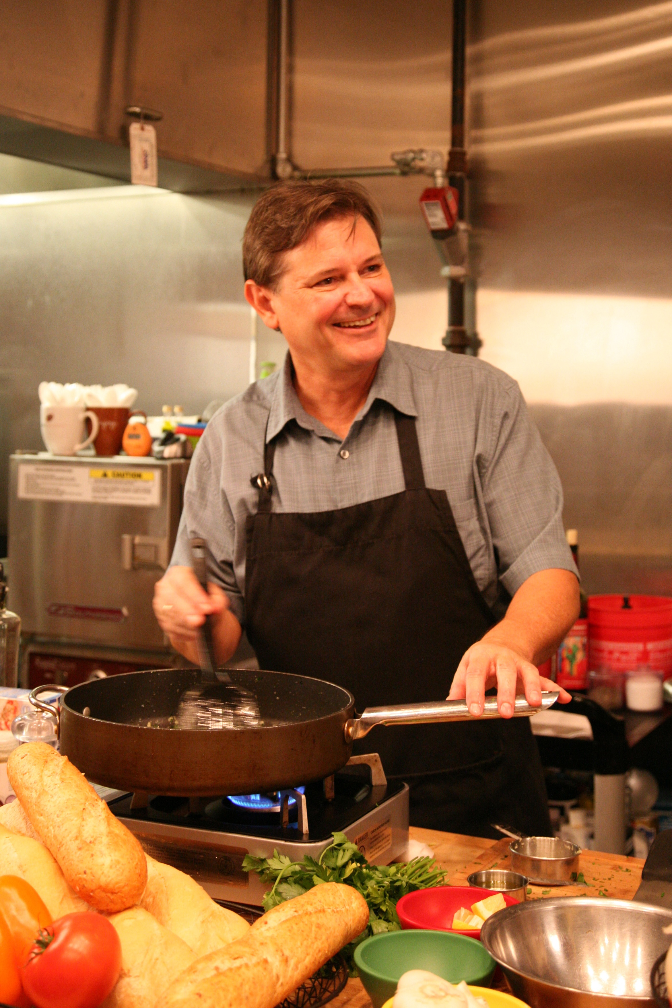 Warren cooking and smiling