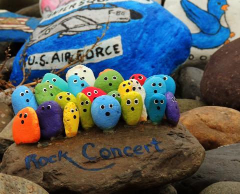 Group of rocks with faces painted on them.