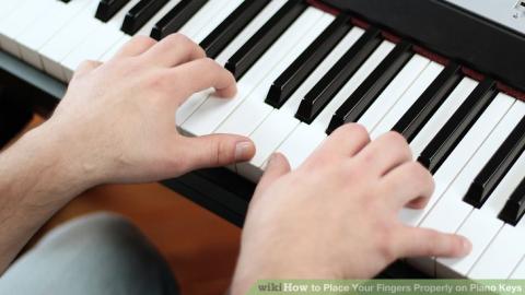 Hands playing a piano