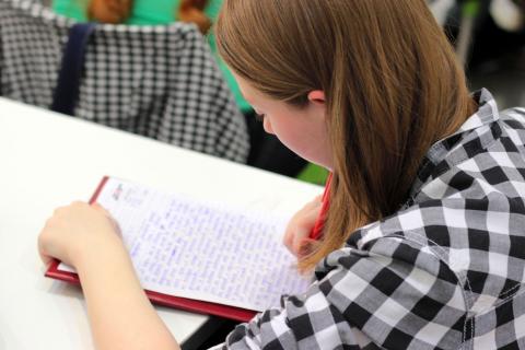 Girl writing on paper.