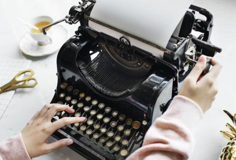 Female hands on typewriter