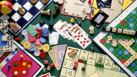 Collage of table-top board games and playing cards.