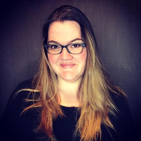 A headshot of author Sarah MacLean, set against a dark purple background.