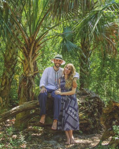 Man and woman in a jungle posing for a picture.