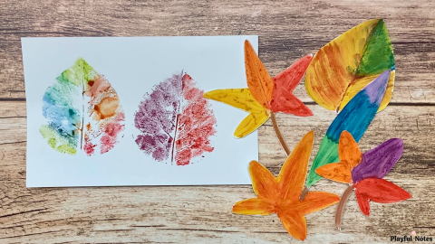 Leaves of different sizes and shapes painted and pressed on a white paper.