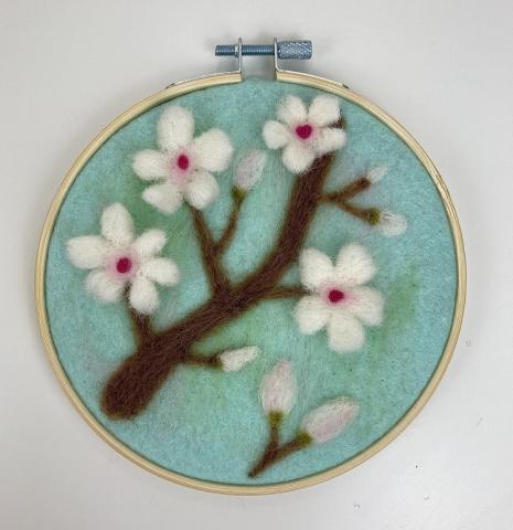 A picture of the completed felt hoop art project.