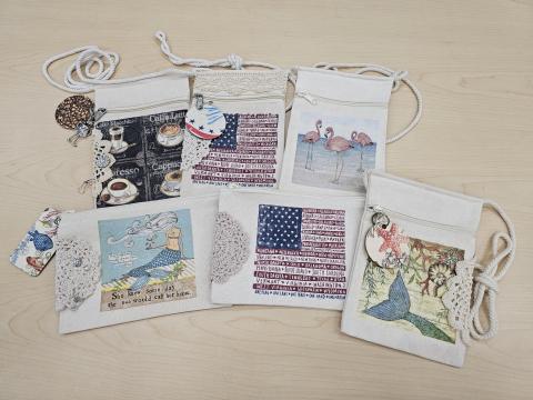 A picture of six decoupage bags made using different decorative napkins.