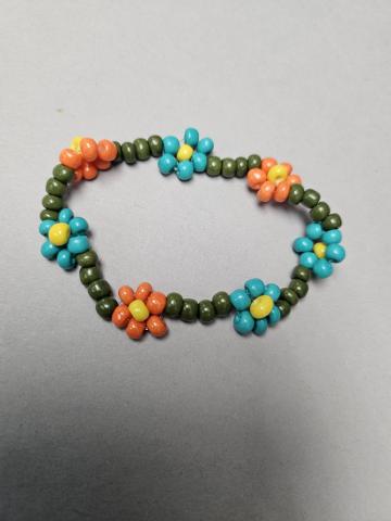 A beaded bracelet with flowers made of beads.