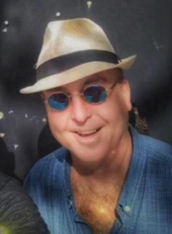 A headshot of Glenn Allen wearing a hat and sunglasses.