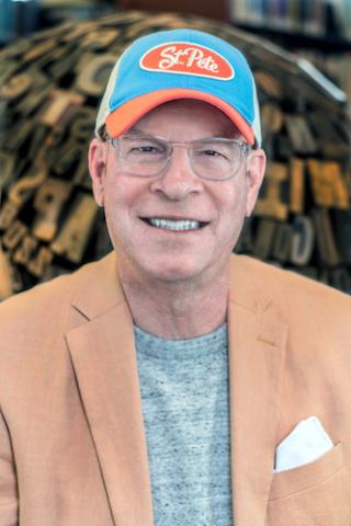 Headshot of author Roy Pere Clark wearing a baseball cap.