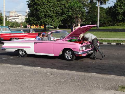 Pink and white vintage convertible car in Cuba.