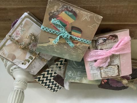 Journal notebooks covered with paper bags and decorated with pictures and ribbons.