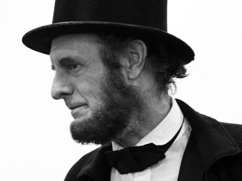 Kevin Wood as Mr. Lincoln looks to the left of the frame in this black and white photograph