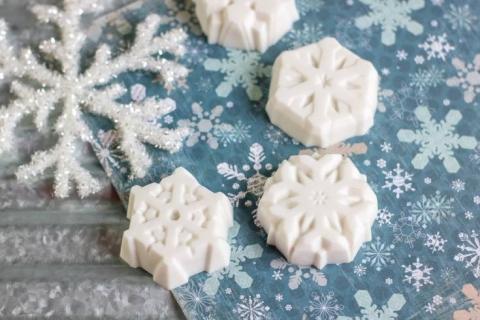 3 white bars of soap in the shape of snowflakes 