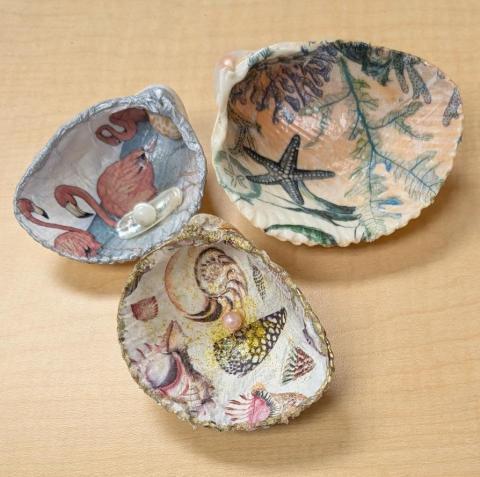 Three seashells with hand-painted designs 