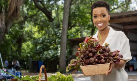 Woman holding a basket of beets.