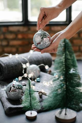 a woman holding a handmade ornament