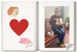 Picture of Laurie on a book page. She is holding a book she had folded into a heart. Next to her is a picture of a hedgehog, mouse, and a heart