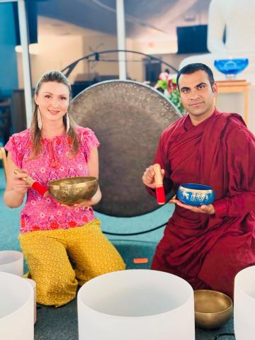 Bhante Chan sitting with some singing bowls