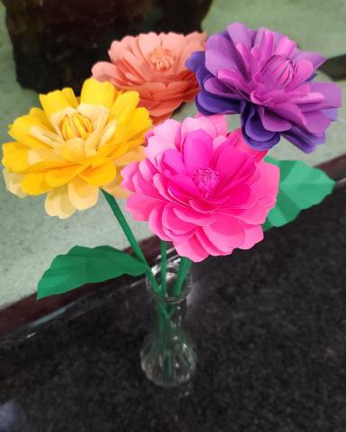 A bouquet of paper dahlias in different colors.