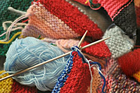 Skeins of yarn with a pair of knitting needles.