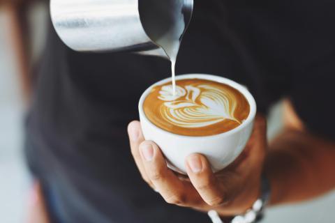 Barista pouring cup of coffee