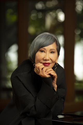 A headshot of author Amy Tan taken outdoors.