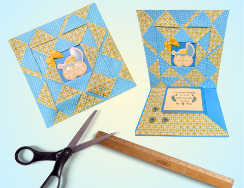 Handmade greeting card next to scissors and a ruler