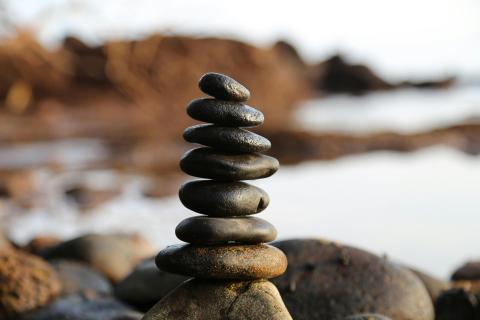 peaceful stacked rocks by the water