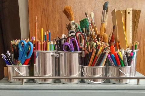 Art supplies in tin cans