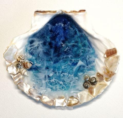 resin ocean with shells inside a large scallop shell