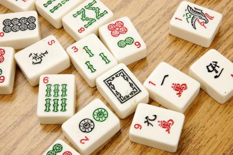 mahjong tiles spread out on a table.