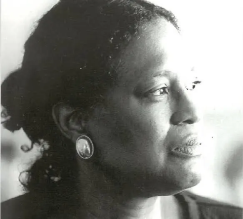 a black and white photo of a woman looking to her left