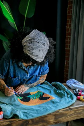 person painting t-shirts