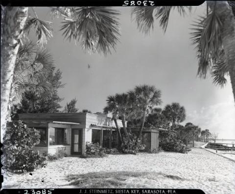 Black and white negative depicts an exterior view of a Ralph Twitchell-designed house on the beach; undated