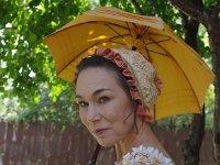 Debra Miller as Jane Austen holding a parasol