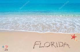 water and beach with the word Florida written in sand